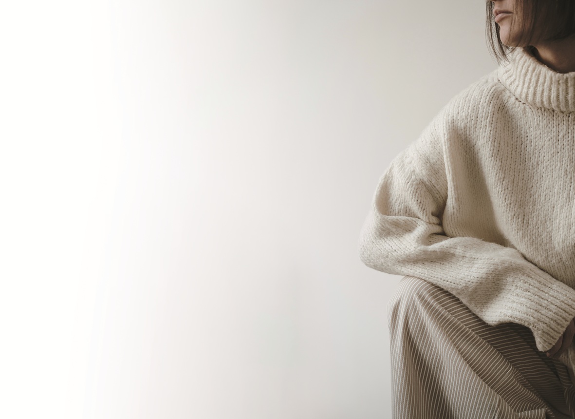 Closeup view of young pretty woman in beige sweater. Aesthetic f Closeup view of young pretty woman in beige sweater. Aesthetic f