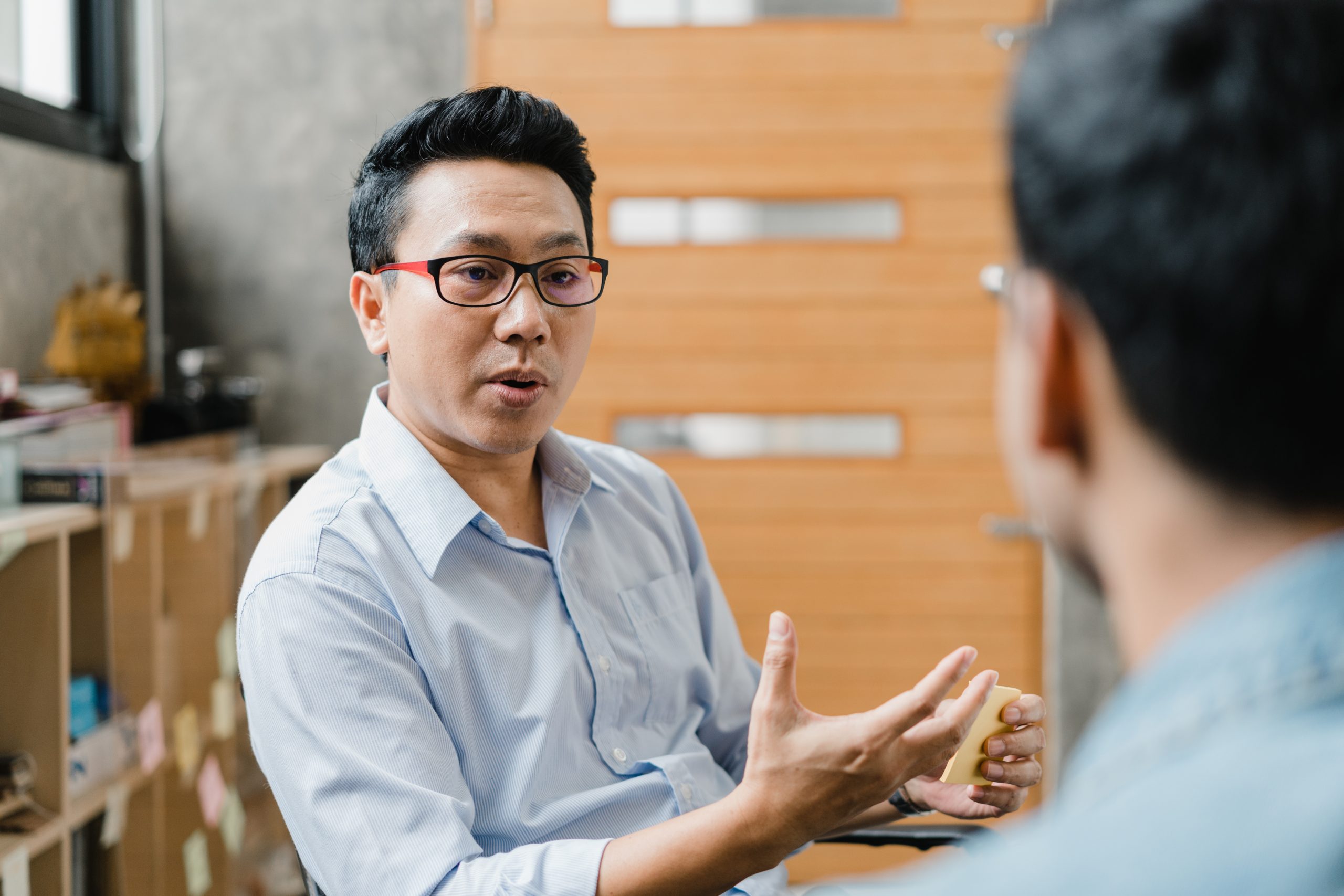 Asia businesspeople chatting to intern discussing job interview
