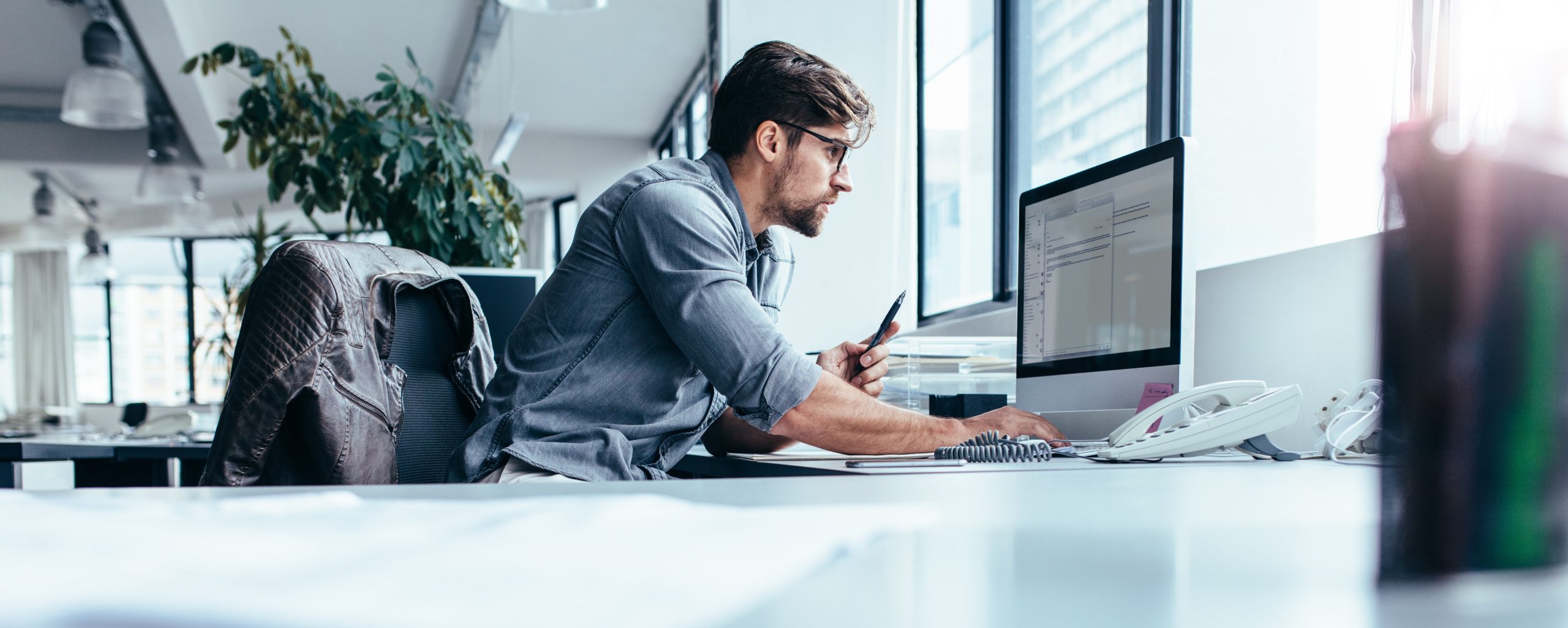 Young businessman in office working on computer